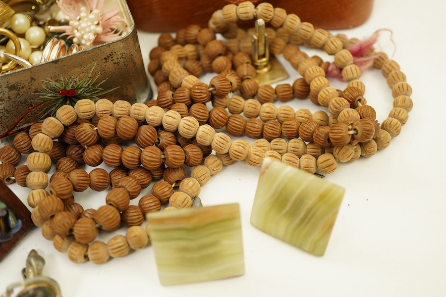 A small collection of costume jewellery, a Christian Dior golf club tie clip, a pair of simulated pearl screwback earrings, stamped 9ct, an Indian silver locket, assorted cufflinks etc